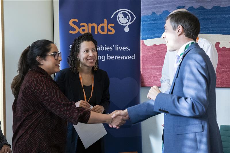 Image of bereaved parents Amarjit Matharoom and Rosalyn Springer beside Adrian Ramsey MP a at the Sands and Tommys joint event in parliament